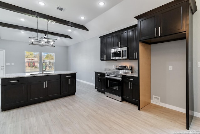 kitchen with lofted ceiling with beams, sink, light wood-type flooring, light stone counters, and stainless steel appliances