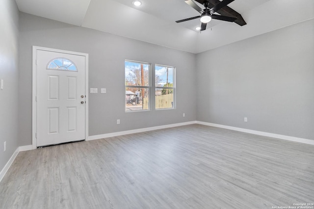 foyer entrance featuring ceiling fan, light wood-type flooring, and lofted ceiling