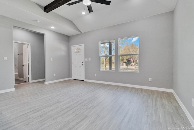 spare room with vaulted ceiling with beams, light hardwood / wood-style floors, and ceiling fan