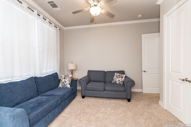 carpeted living room featuring ceiling fan and ornamental molding