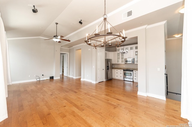 unfurnished living room with ceiling fan with notable chandelier, light wood-type flooring, ornamental molding, and lofted ceiling