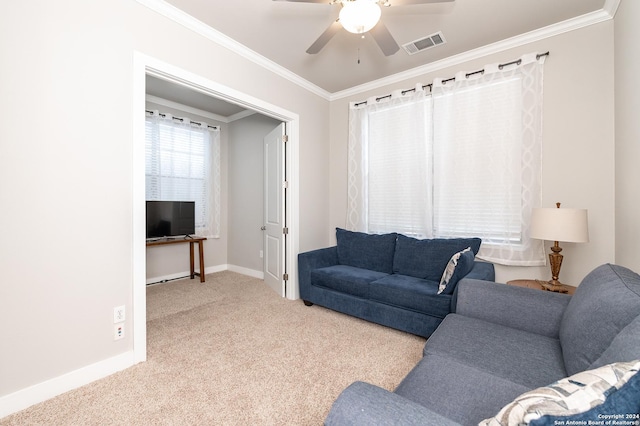 living room with crown molding, ceiling fan, and light colored carpet