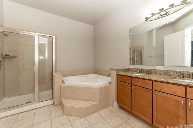 bathroom featuring tile patterned floors, vanity, and shower with separate bathtub