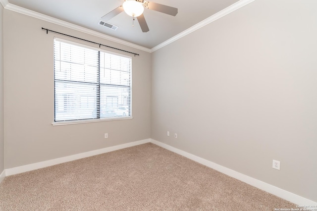 empty room with ceiling fan, carpet floors, and crown molding