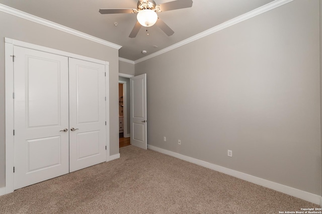 unfurnished bedroom featuring ceiling fan, a closet, carpet, and ornamental molding