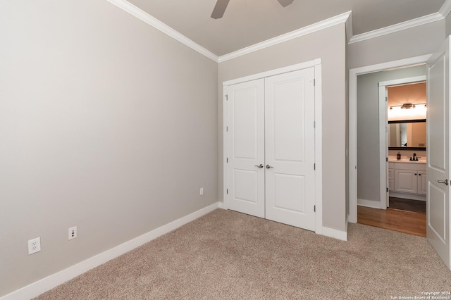 unfurnished bedroom featuring carpet, ceiling fan, and crown molding