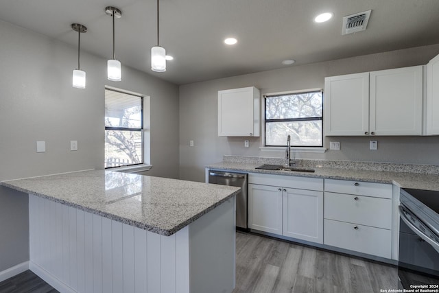 kitchen with sink, decorative light fixtures, light hardwood / wood-style flooring, dishwasher, and white cabinets