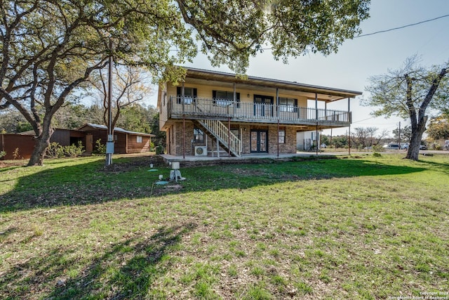 back of property featuring a patio area, a yard, and french doors