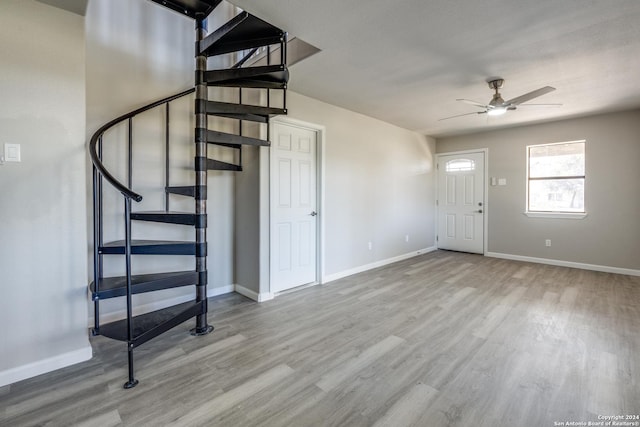 foyer with ceiling fan and light hardwood / wood-style flooring