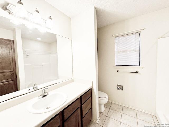 bathroom featuring tile patterned flooring, vanity, toilet, and a textured ceiling