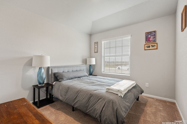 bedroom featuring light colored carpet and vaulted ceiling