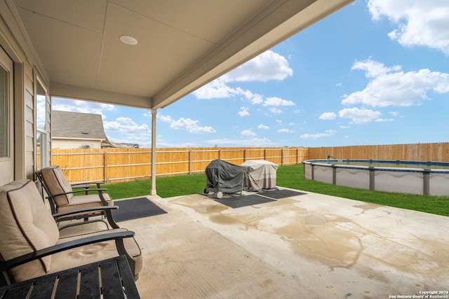 view of patio featuring a fenced in pool