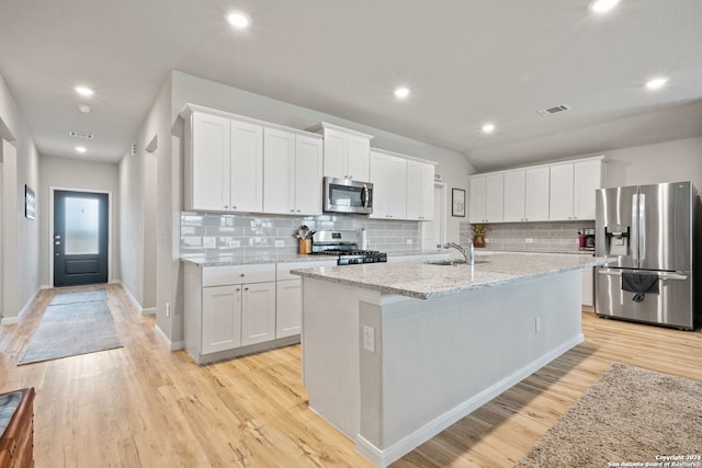 kitchen featuring sink, stainless steel appliances, light hardwood / wood-style flooring, a kitchen island with sink, and white cabinets