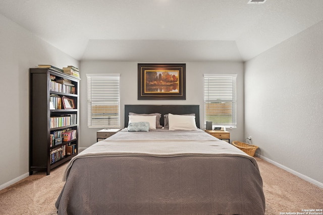 carpeted bedroom featuring lofted ceiling