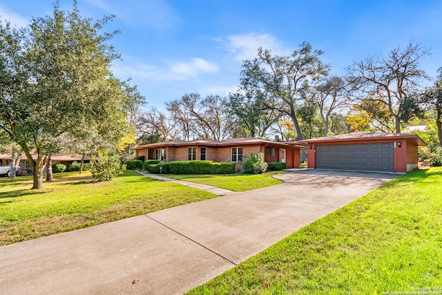 single story home with a garage and a front yard