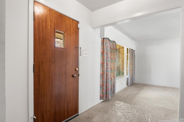 view of carpeted foyer entrance