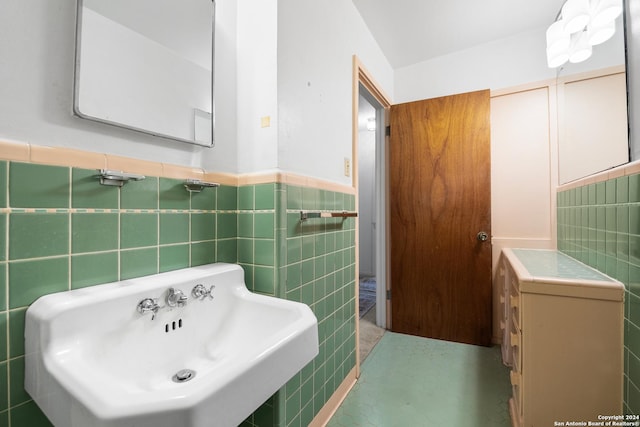 bathroom with sink and tile walls