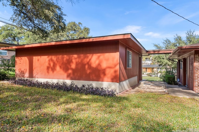 view of side of home featuring a lawn