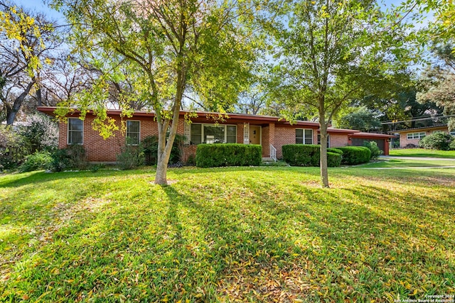 single story home featuring a garage and a front yard