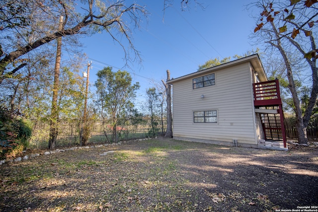 view of property exterior featuring a wooden deck