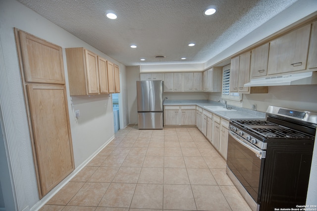 kitchen with light brown cabinets, light tile patterned floors, and appliances with stainless steel finishes