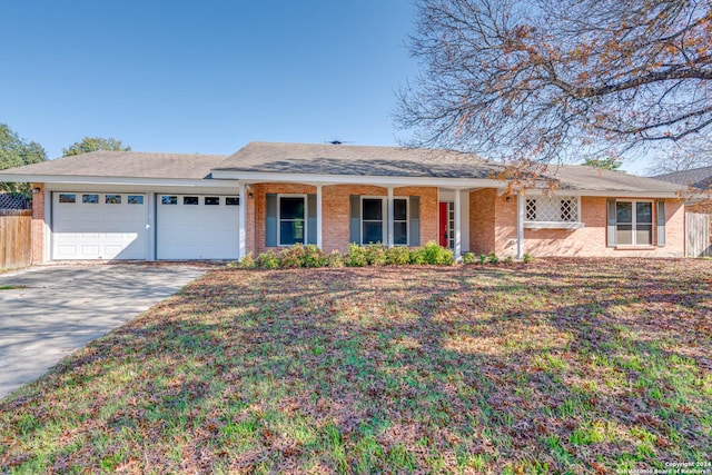 ranch-style home with a porch and a garage