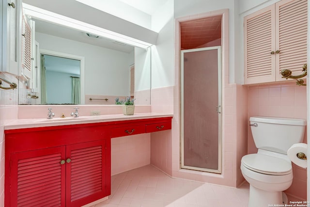 bathroom featuring tile patterned flooring, vanity, an enclosed shower, and tile walls