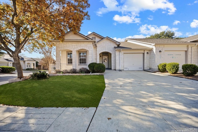 ranch-style home with a porch, a garage, and a front lawn