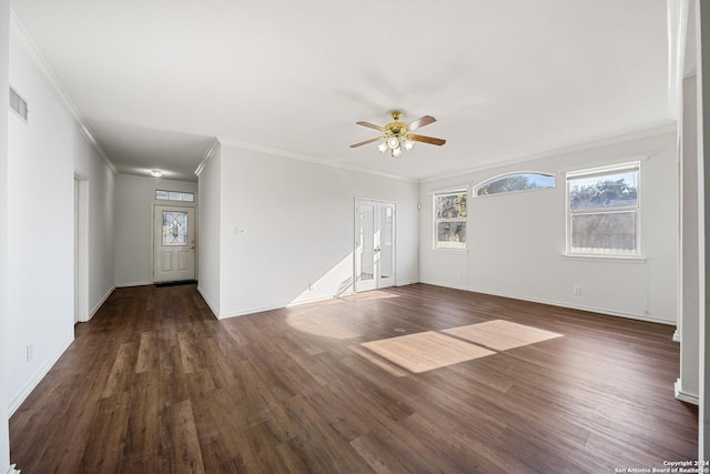 spare room featuring dark hardwood / wood-style floors, ceiling fan, and crown molding