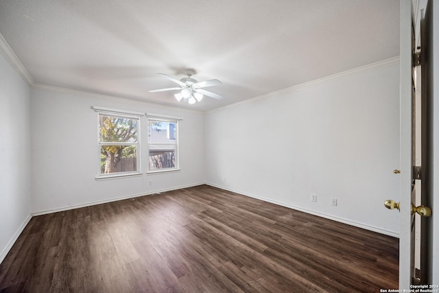 empty room featuring ceiling fan, ornamental molding, and dark wood-type flooring