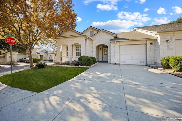 view of front of house with a front yard and a garage