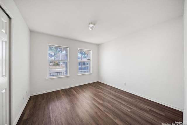 unfurnished room featuring dark hardwood / wood-style floors