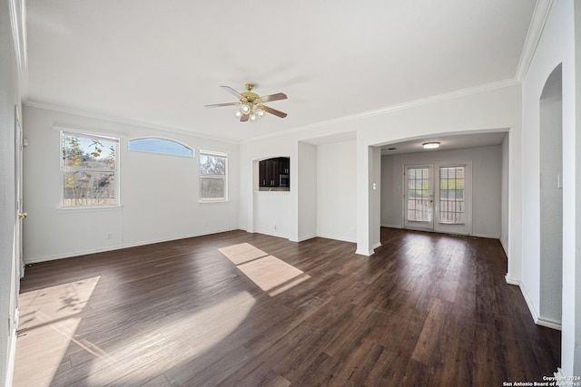 spare room with dark hardwood / wood-style flooring, ceiling fan, and ornamental molding