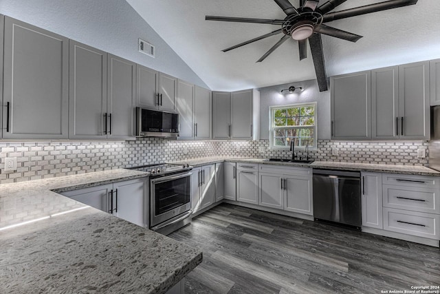 kitchen featuring decorative backsplash, appliances with stainless steel finishes, a textured ceiling, and sink