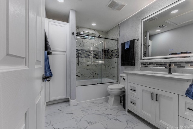 full bathroom featuring vanity, toilet, and combined bath / shower with glass door