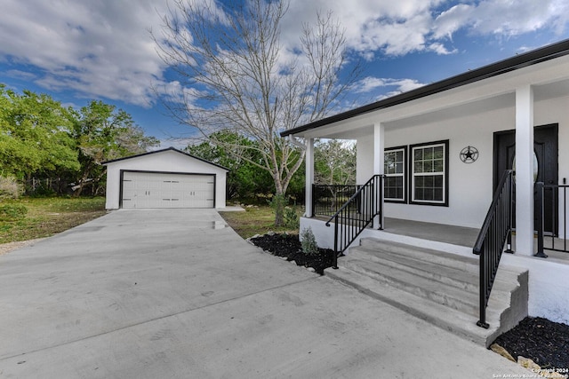 deck with a porch, a garage, and an outdoor structure