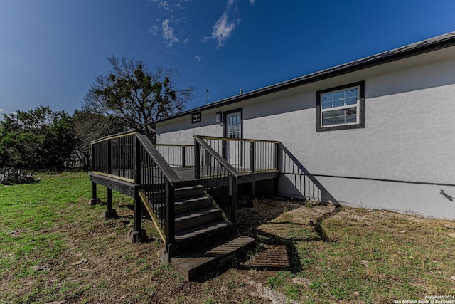 exterior space featuring a lawn and a wooden deck