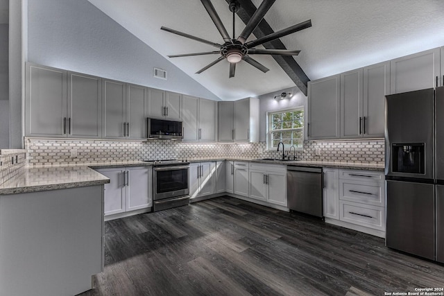 kitchen with ceiling fan, sink, dark hardwood / wood-style floors, backsplash, and appliances with stainless steel finishes