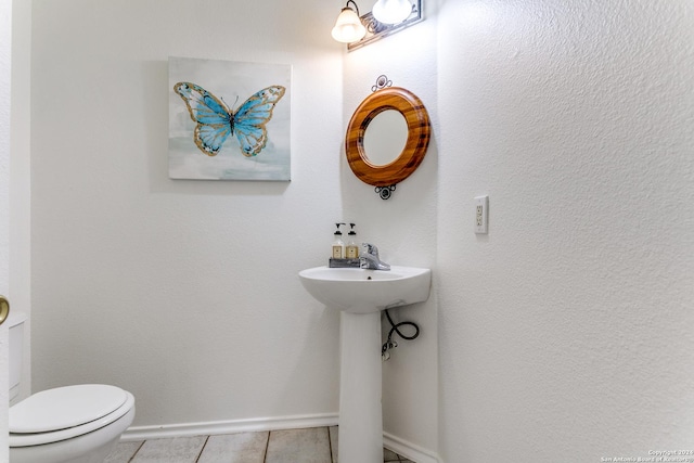 bathroom with tile patterned floors and toilet