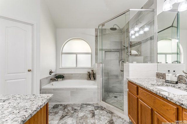 bathroom featuring plus walk in shower and vanity