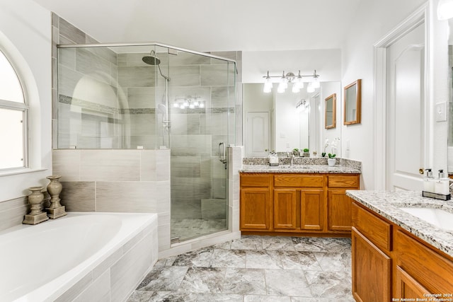 bathroom featuring vanity and separate shower and tub