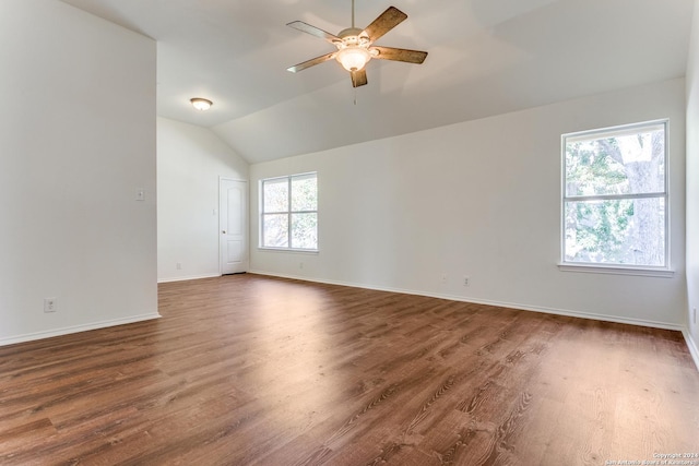 empty room with dark hardwood / wood-style floors, vaulted ceiling, and ceiling fan