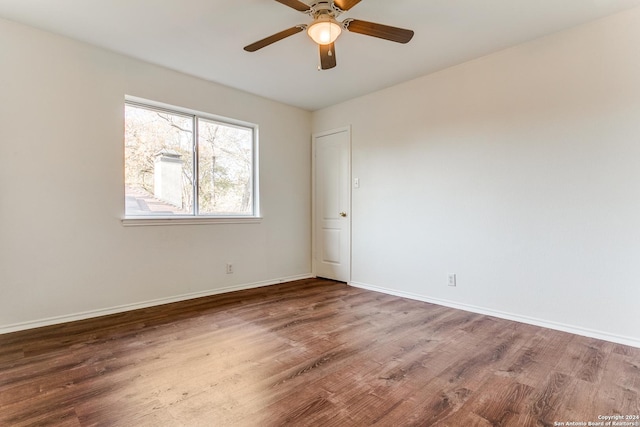 spare room featuring hardwood / wood-style floors and ceiling fan