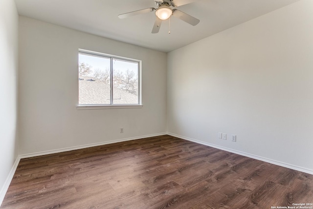 empty room featuring ceiling fan and dark hardwood / wood-style flooring