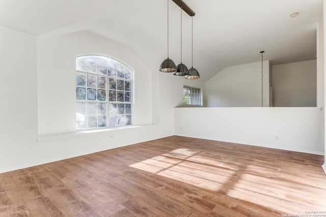 unfurnished dining area with wood-type flooring and lofted ceiling