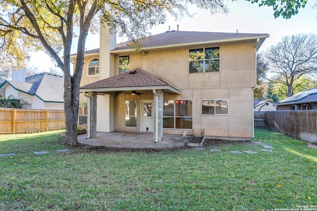 back of house with a lawn, ceiling fan, and a patio area