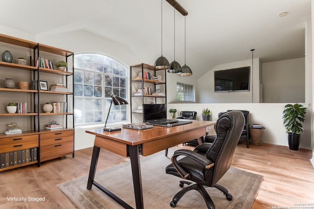 office area featuring vaulted ceiling and light hardwood / wood-style flooring