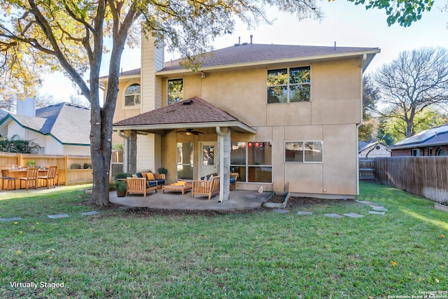 back of house with ceiling fan, an outdoor hangout area, a patio area, and a lawn