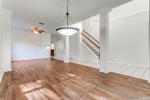 unfurnished living room featuring wood-type flooring and ceiling fan