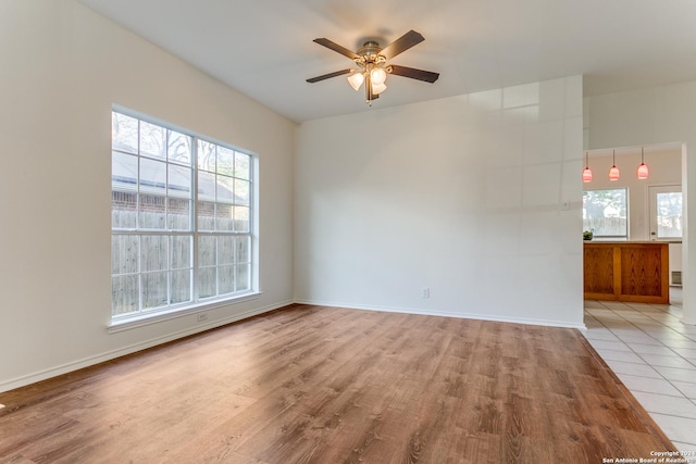 empty room featuring ceiling fan and light wood-type flooring